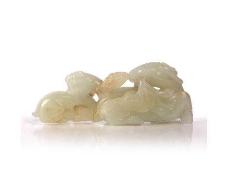 White jade pebble Chinese, 19th Century pierced and carved as a reclining deer and young, both holding sprays of ling-chi fun