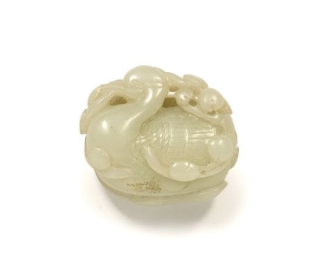 White jade pebble Chinese, Qing period pierced and carved as a seated duck like crane holding a spray of peaches symbolising 