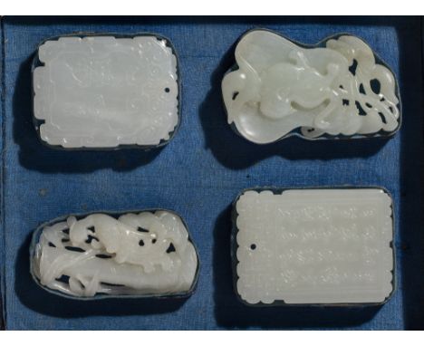 Collection of four white jade pendants Chinese, 18th Century mounted in a black and blue fitted box including a rectangular p