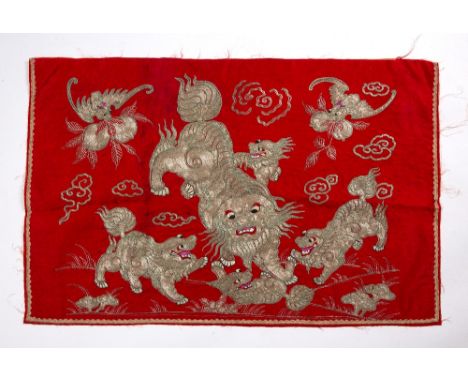 Red ground silk panel Chinese embroidered in silver metal thread with a group of playful kylins, 50cm x 78cm