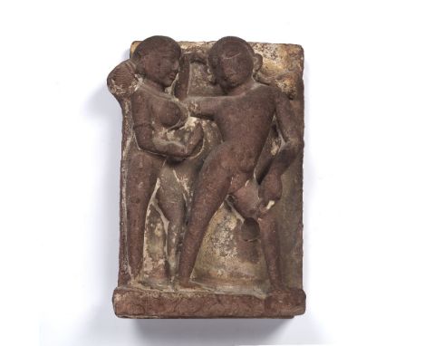 Carved relief sandstone panel North or Central India, possibly 9th/10th Century depicting Gana and an attendant, 38cm x 27cm 