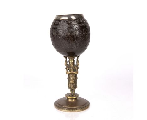 Coconut cup on metal base Indian carved with panels of gods on a shiva column, 14.75cm high Condition: wear to metal and crac