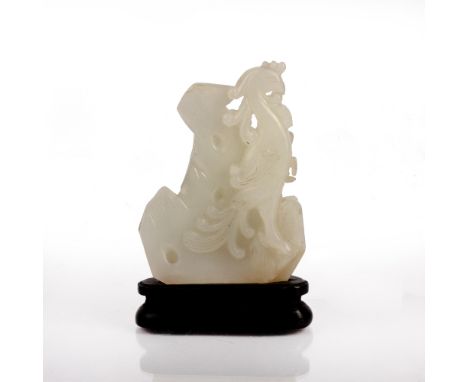 White jade carving Chinese, 18th Century depicting a phoenix set against a mountain, supported by a separate wooden stand, 7c