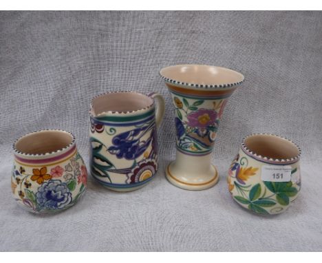 THREE POOLE POTTERY VASES with bright floral decoration and a similar blue bird jug