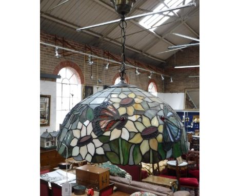 A TIFFANY STYLE HANGING LAMP SHADE decorated with butterflies