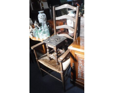 AN EARLY 20TH CENTURY LADDER BACK ARMCHAIR with rush seat and a small carved oak joint stool