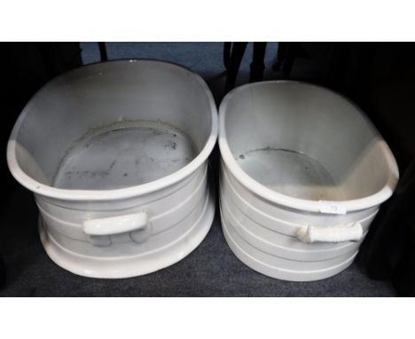 A 19TH CENTURY WHITE CERAMIC FOOT BATH and another similar (examine)