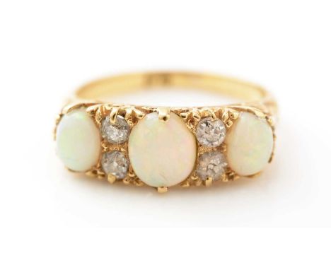 A Victorian opal and diamond ring, the three graduated oval opal cabochons pated by pairs of old cut diamonds, in 18ct yellow