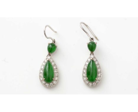 A pair of jade and diamond cluster drop earrings, each with a main drop of pear-shaped jade cabochon surrounded by seventeen 