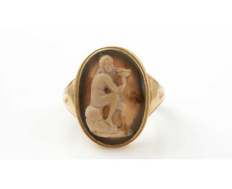 A 19th Century hardstone cameo ring, the oval carved banded agate plaque depicting a classical female nude holding a vessel, 