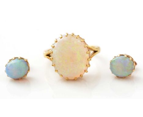 An opal ring and earrings, the ring set with oval opal cabochon measuring 15.5 x 12.6mm, in 18ct yellow gold mount and shank,