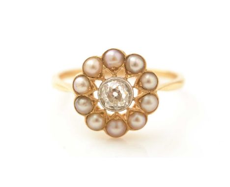 A Victorian diamond and half-pearl cluster ring, the old cut diamond weighing approximately 0.55carats in platinum mount, sur