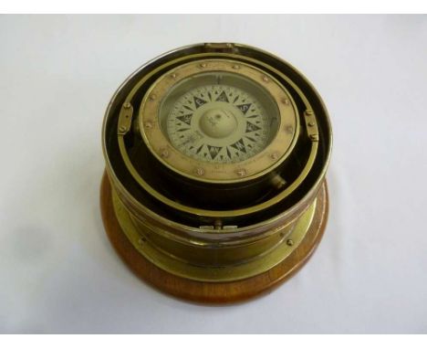 A compass by Henry Browne &amp; Son mounted in brass and on wooden base