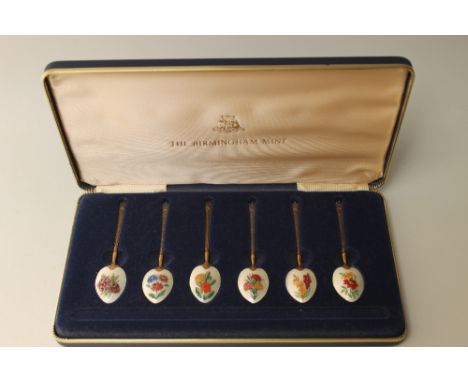 A SET OF SIX 'BIRMINGHAM MINT' HALLMARKED SILVER AND ENAMEL FLORAL DESIGN SPOONS, each detailed with a different flower to th