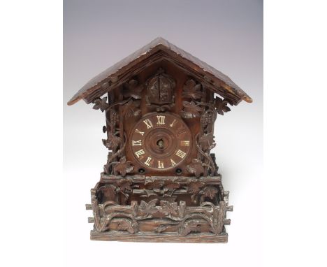 A LATE 19TH CENTURY TWIN FUSEE CUCKOO CLOCK ATTRIBUTED TO JOHANN BAPTISTE BEHA, the chalet style case with carved grape and v
