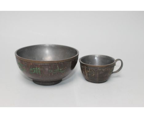 A CHINESE COCONUT BOWL AND TEACUP, the bowl being metal lined with Oriental script, engraved and highlighted in green with a 