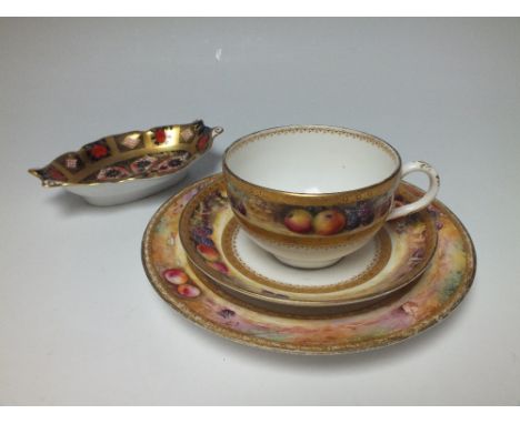 AN EARLY 20TH CENTURY ROYAL WORCESTER TRIO, white ground with hand painted border of orchard fruits and gilt banding, compris