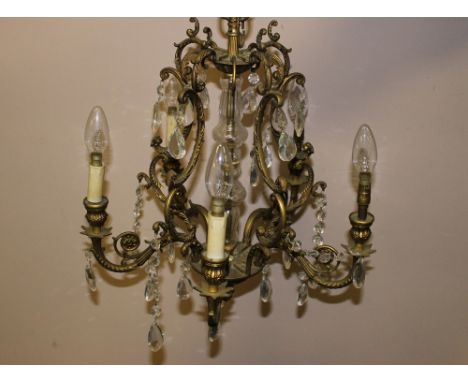 A GILT METAL AND CRYSTAL SIX LIGHT CHANDELIER, converted for electricity, H 55 cm