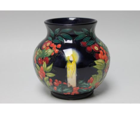 A MOORCROFT 'GUIDING LIGHT' LIMITED EDITION VASE NUMBER 5 OF 50, featuring a candle within a Christmas foliage styled cartouc