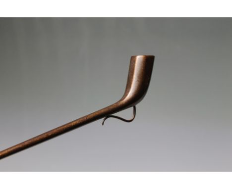 A RARE 18TH CENTURY CHURCH WARDEN'S STEEL PIPE, the typical long tapered stem leading to an octagonal bowl, with a scroll bel