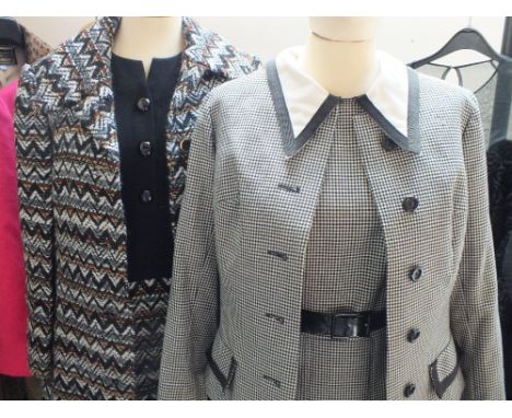 TWO VINTAGE 1970S HARDY AMIES LADIES TWO PIECE DRESS SUITS, comprising a houndstooth dress with short jacket, and a black fab