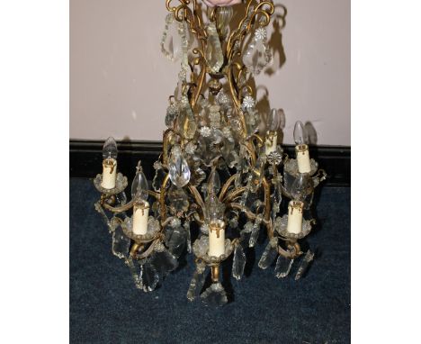 A LATE NINETEENTH / EARLY TWENTIETH CENTURY FRENCH GILT BRASS AND CRYSTAL LUSTRE EIGHT LIGHT CHANDELIER, converted for electr