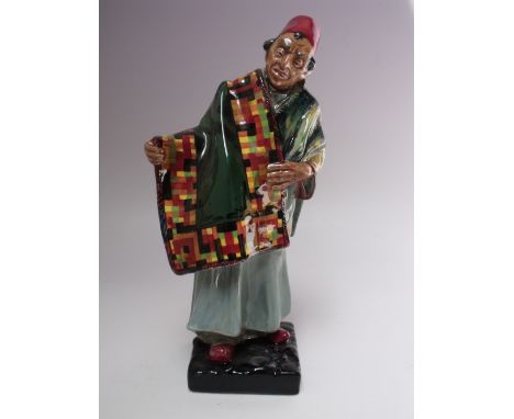 A ROYAL DOULTON 'CARPET SELLER' FIGURE - MODEL HN1464, printed marks to base, H 22.5 cm Buyers - for shipping pricing on this