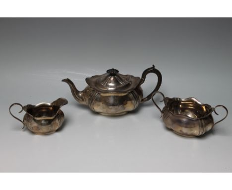 A HALLMARKED SILVER THREE PIECE TEA SERVICE - SHEFFIELD 1916, of bulbous shaped form, approx combined weight 985 g Buyers - f