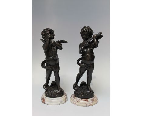 A PAIR OF CONTINENTAL SPELTER CHERUBIC MODELS PLAYING MUSICAL INSTRUMENTS, after Moreau, on marble bases H 33 cm (including b