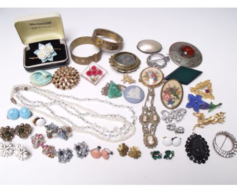 A COLLECTION OF VINTAGE COSTUME JEWELLERY, comprising mostly brooches, including some signed examples, together with a select