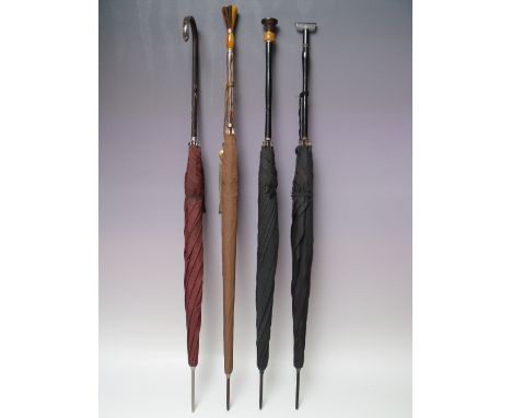 AN EARLY 20TH CENTURY 'S FOX &amp; CO' PARAGON PARASOL, faux amber style detachable handle with yellow metal banding, complet