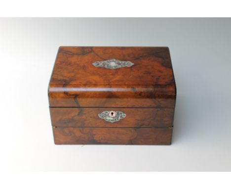 A VICTORIAN WALNUT WRITING SLOPE, the hinged lid bearing a mother-of-pearl inlaid panel to the top, opening to reveal a rever