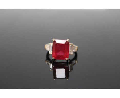 A MODERN 5 CARAT RUBY RING, emerald cut and set in 9 carat gold, ring size N 1/2 Buyers - for shipping pricing on this lot, v