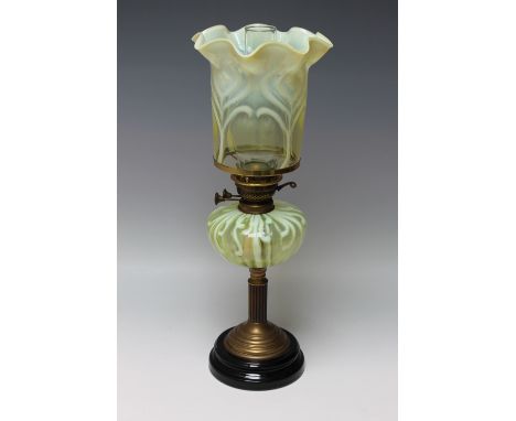 A VICTORIAN VASELINE GLASS OIL LAMP, the lamp with a stepped base leading to a brass Corinthian column, the ovoid glass reser