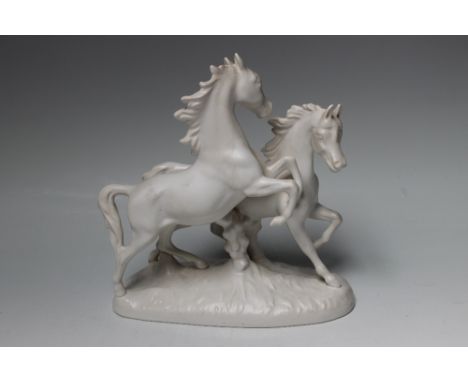 A GOEBEL FIGURE OF HORSES GALLOPING, in an all white finish, Goebel stamp to base, W 23 cm Buyers - for shipping pricing on t