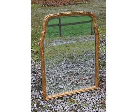 A GILT SHAPED OVERMANTEL MIRROR, late 19th Century, with carved moulded detail to the frame, H 106 cm, W 85 cm