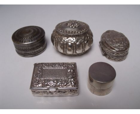 FIVE SILVER AND WHITE METAL TRINKET / PILL BOXES, to include an Egyptian silver oval pill box, the hinged lid with embossed d