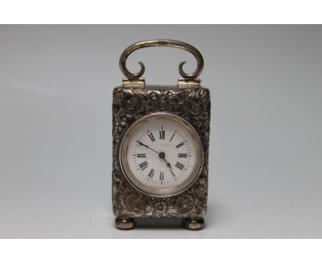 A SILVER SMALL CARRIAGE CLOCK, stamped with the Lion Passant to the inner of the door and upon the handle with the date lette