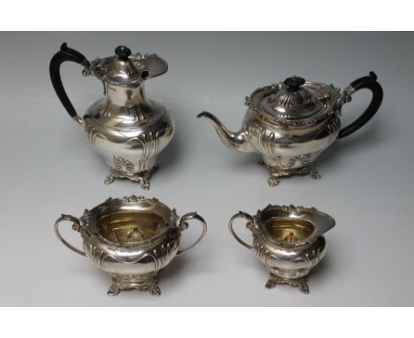 A HEAVY FOUR PIECE TEA SERVICE BY MARTIN HALL AND CO - SHEFFIELD 1911, all four pieces sit upon four shaped feet and have sim