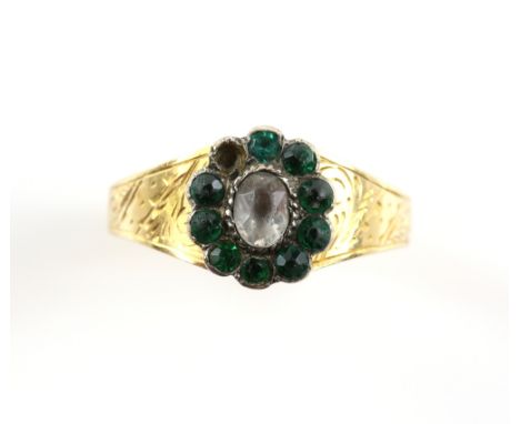 Victorian paste cluster ring, central oval white paste stone surrounded by green paste stones, engraved shoulders, in 18 ct y