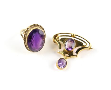 Early 20th C amethyst brooch, with an oval cut amethyst, weighing an estimated 1.50 carats, in a gold openwork plaque, suspen