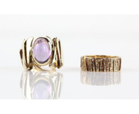 Two vintage rings, one set with oval cabochon cut amethyst, rub over set with textured shoulders, makers mark PJV, ring size 
