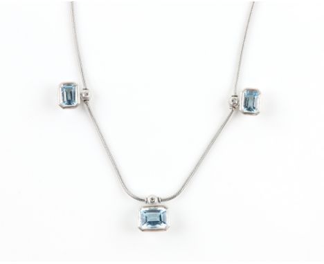 Modern blue topaz and diamond necklace, comprising three octagonal cut blue topaz in rub over settings, each suspended from a