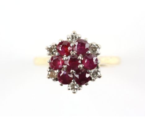 1960's ruby and diamond cluster ring, seven round cut rubies, claw set with six round brilliant cut diamonds, mounted in 18 c