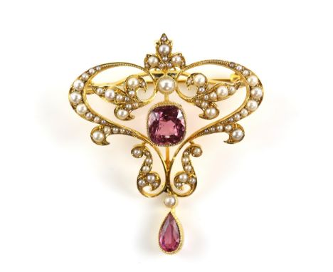 Edwardian pendant brooch, with a central cushion cut pink tourmaline, estimated weight 2.55 carats, set within a seed pearl s