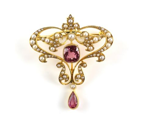 Edwardian pendant brooch, with a central cushion cut pink tourmaline, estimated weight 2.55 carats, set within a seed pearl s