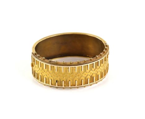 Victorian Etruscan bangle, oval in shape with wirework and bar detailing, front edges decorated with a beaded frame, conceale
