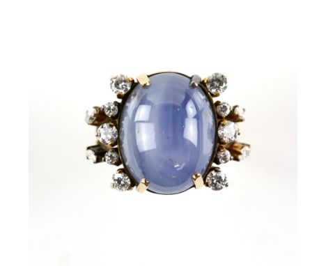 Star sapphire and diamond ring, central oval cabochon cut star sapphire, with a six ray star, weighing an estimated 31.54 car