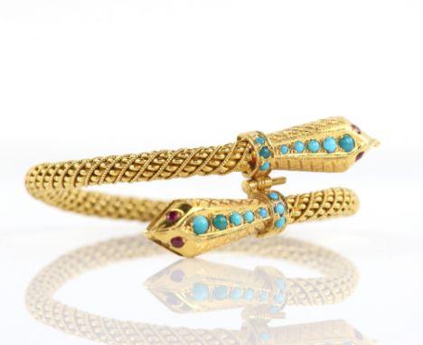 Double headed snake bangle, the textured heads set with round cabochon cut turquoise and round cut ruby eyes, twisted woven b