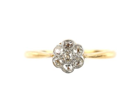 Edwardian flower cluster ring, set with seven old cut diamonds, estimated total weight 0.25 carats, mounted in 18 ct, ring si